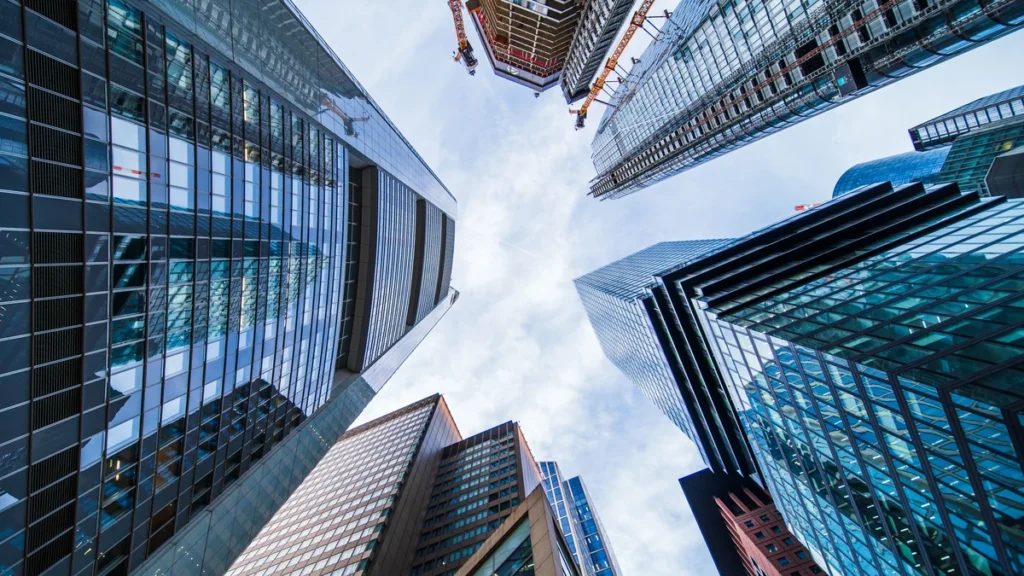 Modern glass office towers viewed from street level in New York City.