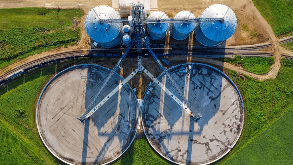 Aerial view of grain storage silos and surrounding agricultural fields in Randolph, Minnesota.