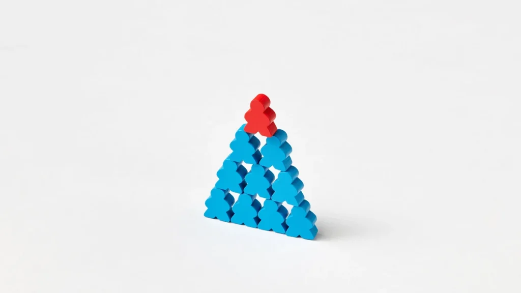 Blue wooden figures arranged in a pyramid with a red figure at the top.
