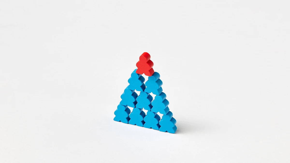 Blue wooden figures arranged in a pyramid with a red figure at the top.