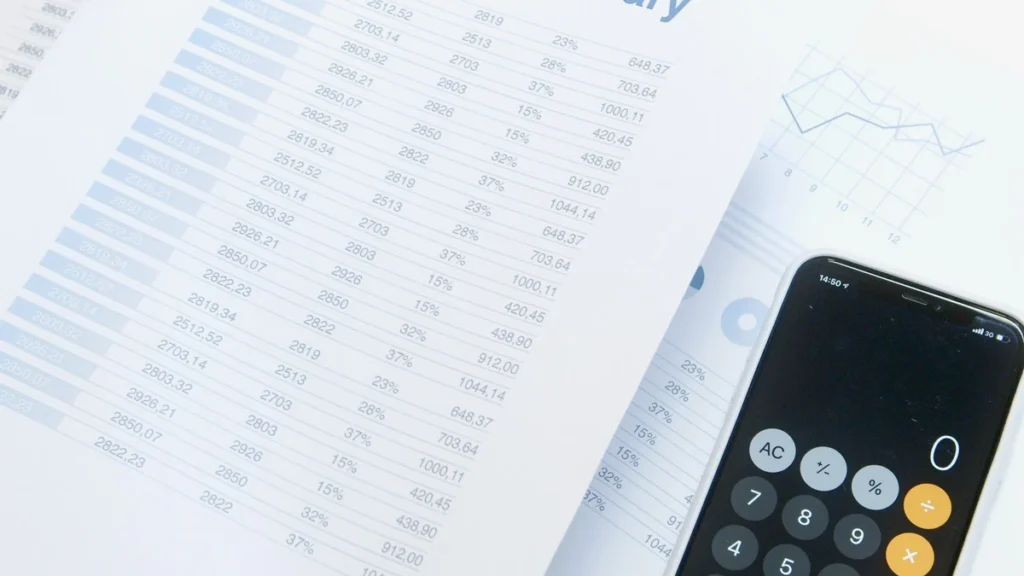 Financial planning documents and a calculator on a desk.