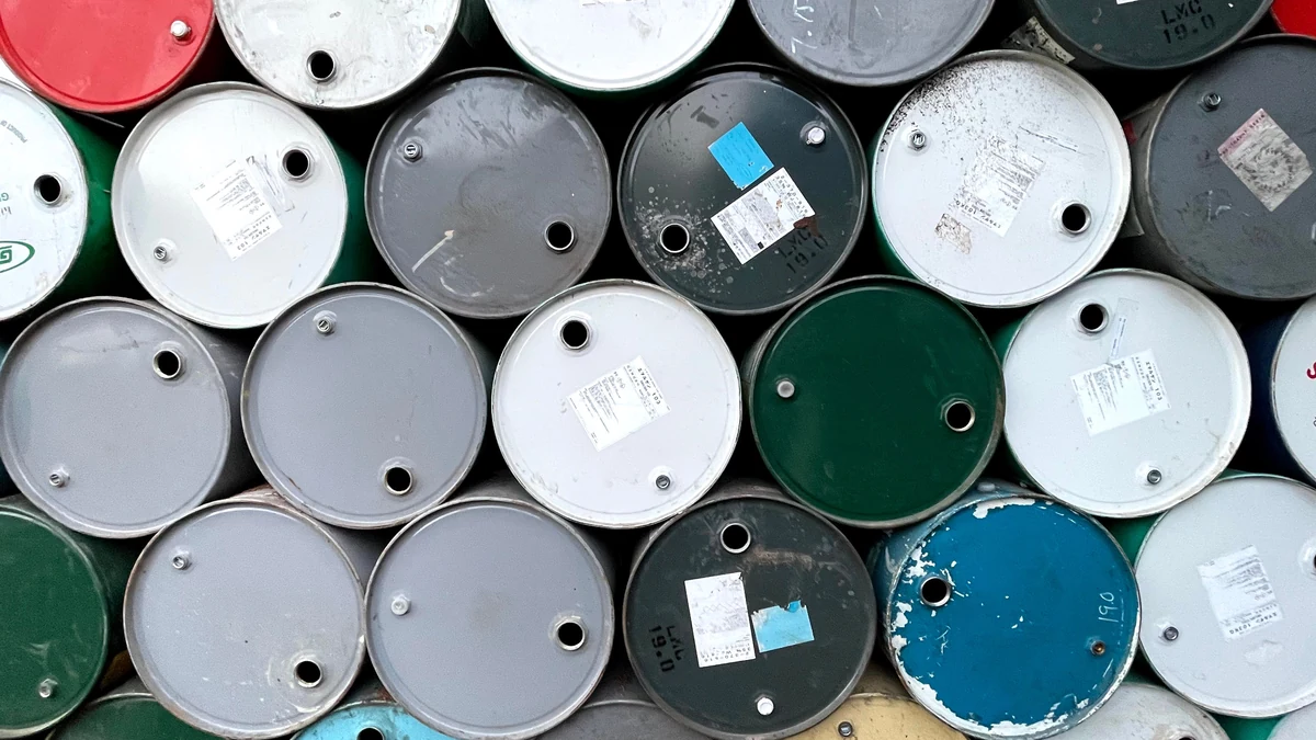 Stacked metal fuel barrels viewed from above.