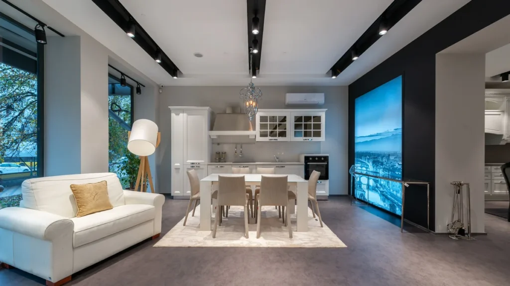 A furnished room displaying household furniture, a dining set and kitchen appliances.