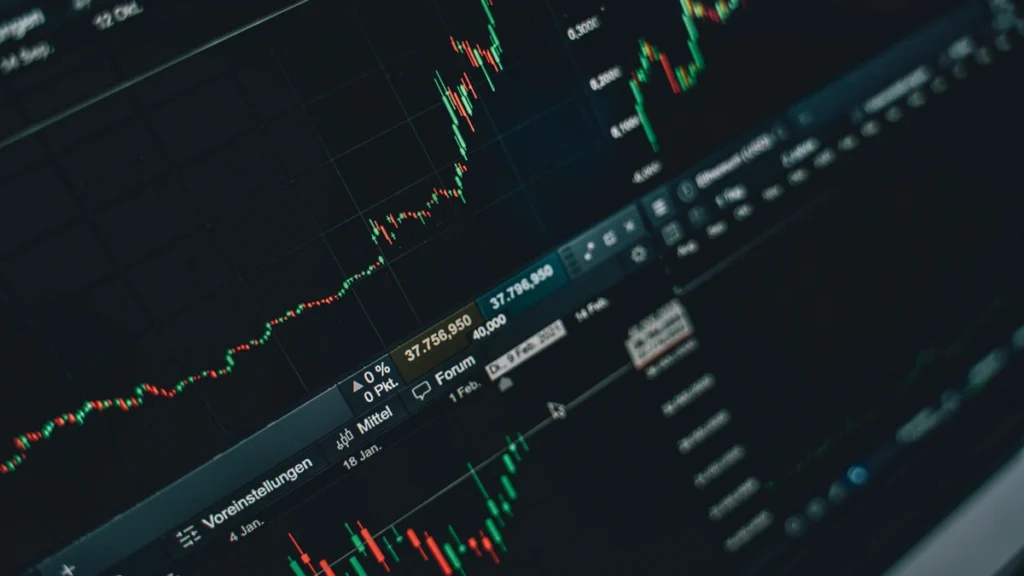 Financial market charts displayed on a laptop screen.