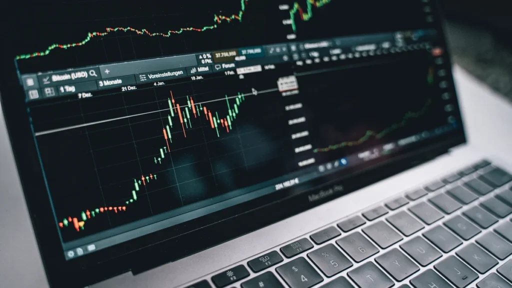 A laptop displaying financial-market price charts.