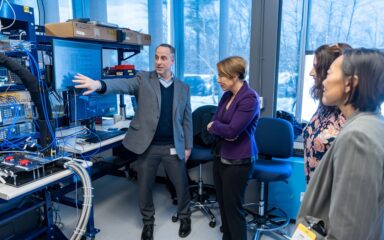 People viewing semiconductor test equipment inside an Analog Devices facility in Wilmington, Massachusetts.