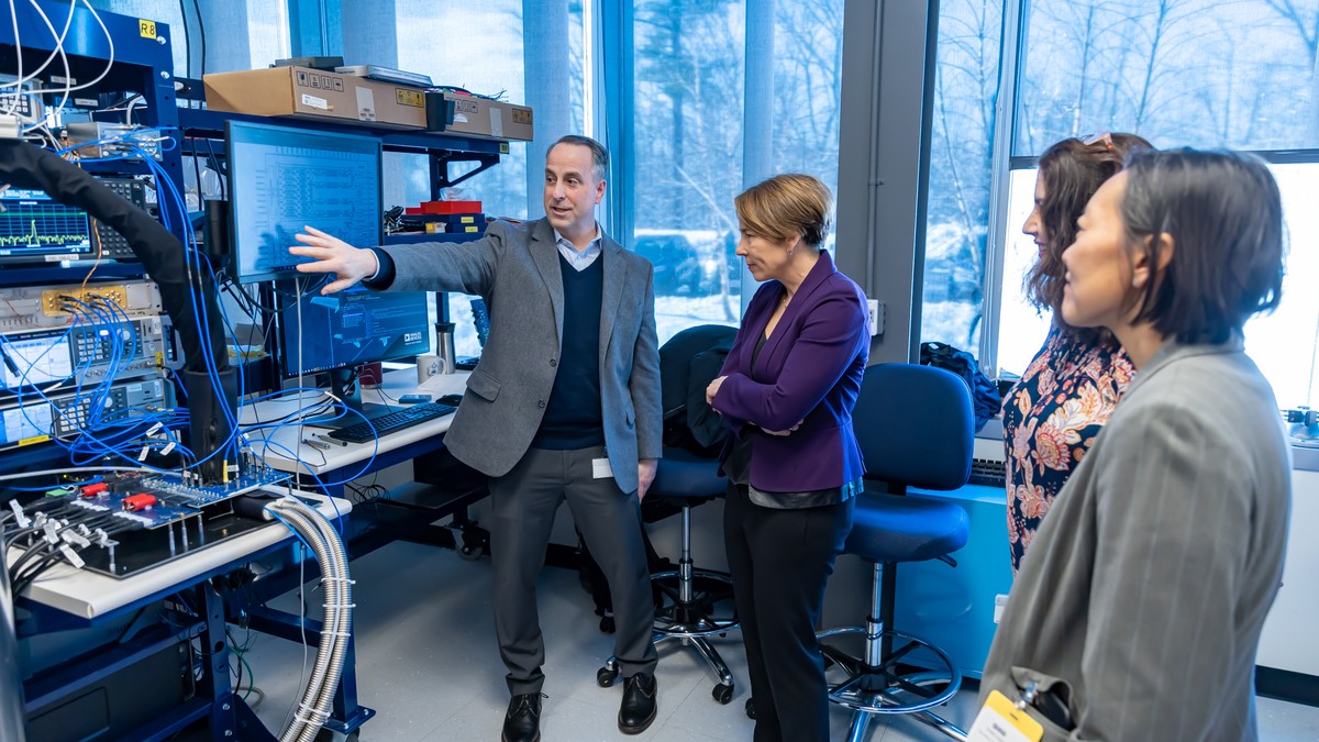 People viewing semiconductor test equipment inside an Analog Devices facility in Wilmington, Massachusetts.
