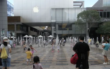 Apple Store in Beijing's Sanlitun district with an Apple logo above an outdoor plaza.