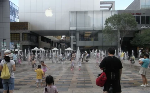 Apple Store in Beijing's Sanlitun district with an Apple logo above an outdoor plaza.