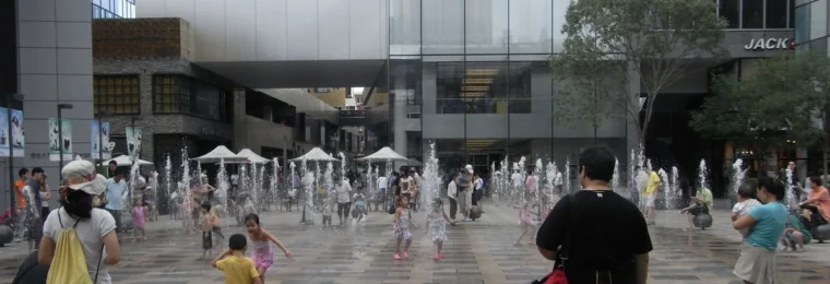 Apple Store in Beijing's Sanlitun district with an Apple logo above an outdoor plaza.