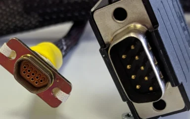 Comparison of a microminiature D connector and a standard DE-9 connector.
