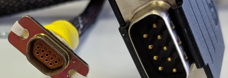 Comparison of a microminiature D connector and a standard DE-9 connector.