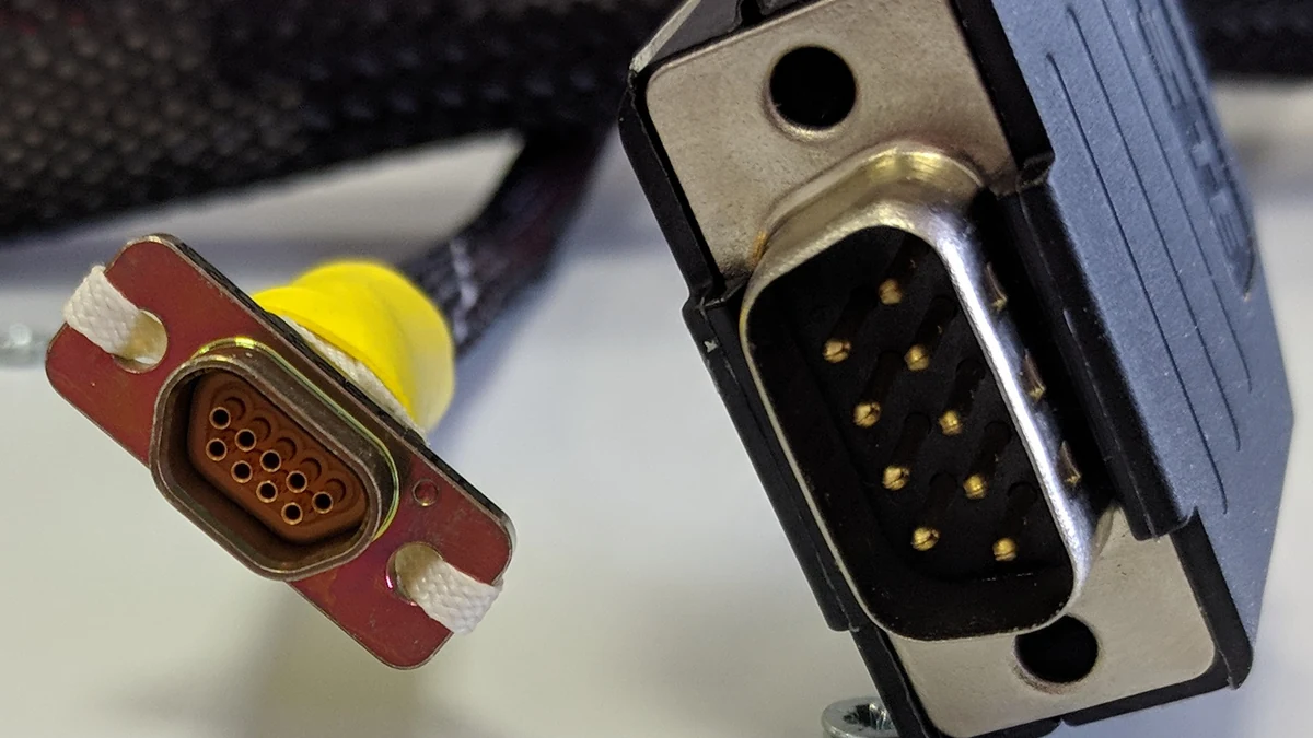 Comparison of a microminiature D connector and a standard DE-9 connector.