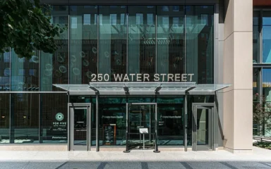 Entrance to Bristol Myers Squibb offices at 250 Water Street in Cambridge, Massachusetts.