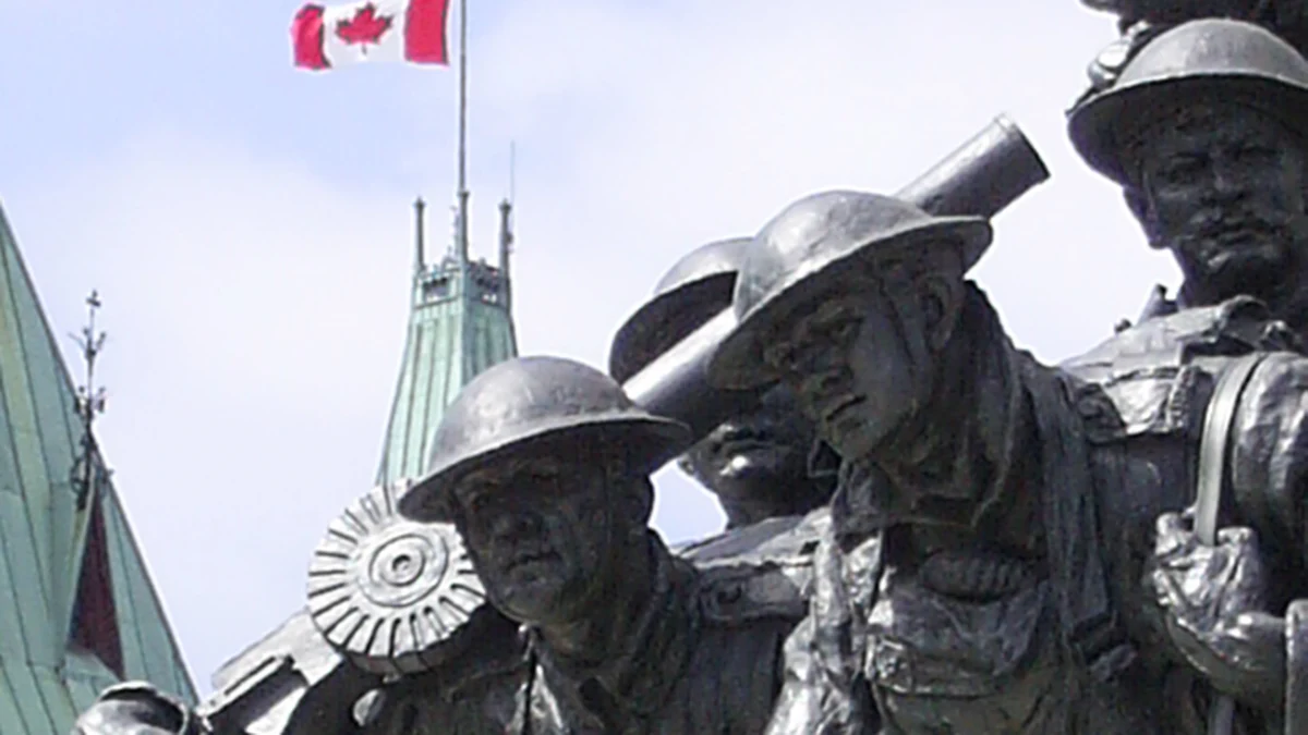 National War Memorial sculpture with the Peace Tower on Parliament Hill in Ottawa.