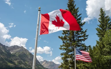 Canadian and U.S. flags flying near the Peace Park Pavilion at Glacier National Park.