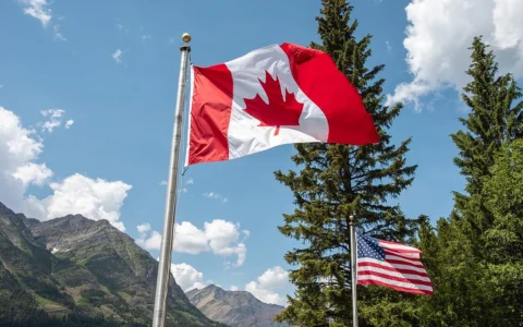 Canadian and U.S. flags flying near the Peace Park Pavilion at Glacier National Park.