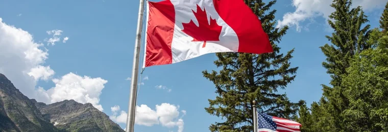 Canadian and U.S. flags flying near the Peace Park Pavilion at Glacier National Park.