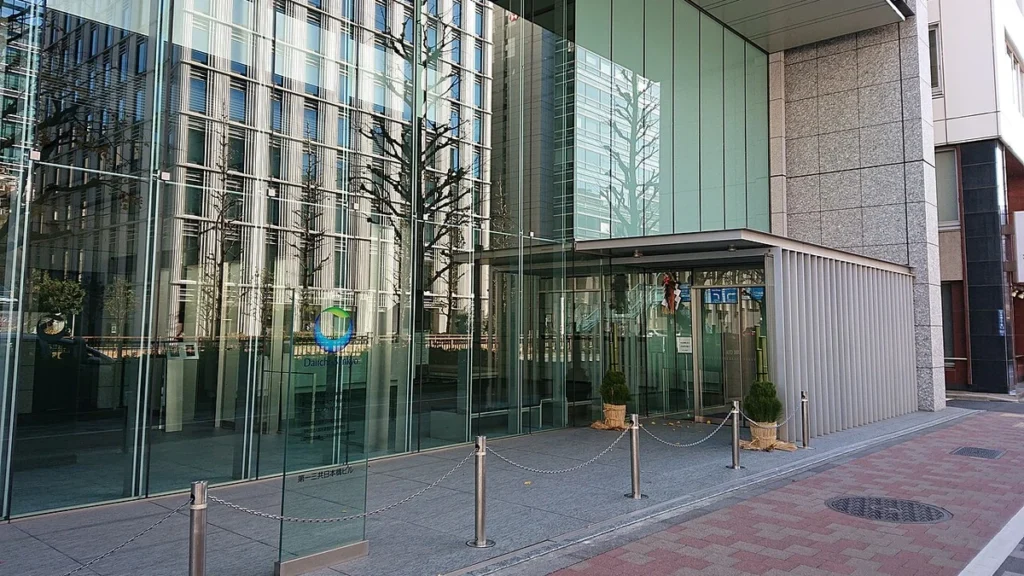Entrance of the Daiichi Sankyo Nihonbashi Building in Tokyo with the street visible in front.