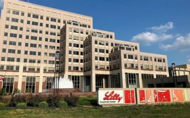 Eli Lilly Corporate Center in Indianapolis with Lilly signage in the foreground.