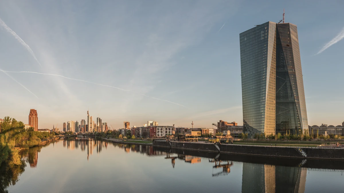 European Central Bank headquarters beside the Frankfurt skyline at dawn.