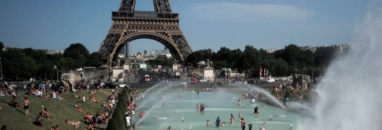 People cooling off in fountains near the Eiffel Tower in Paris during a heatwave.