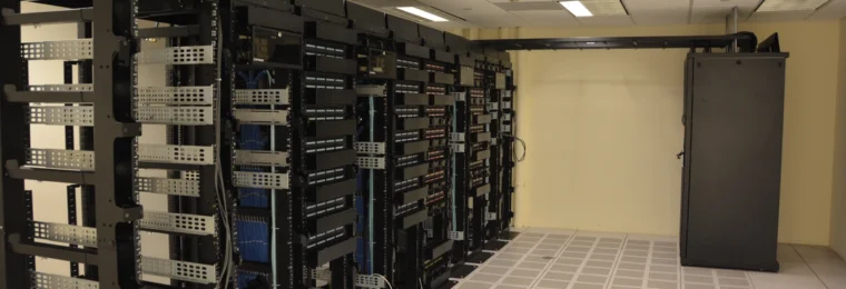 Rows of server racks inside a data center.
