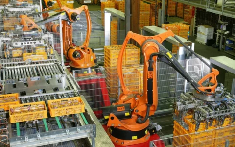 Industrial robots working on an automated production line at a bakery in Germany.