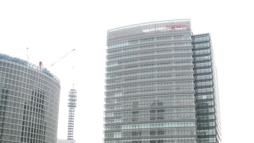 Nissan Global Headquarters building in Yokohama, Japan, with the Nissan sign visible near the top.
