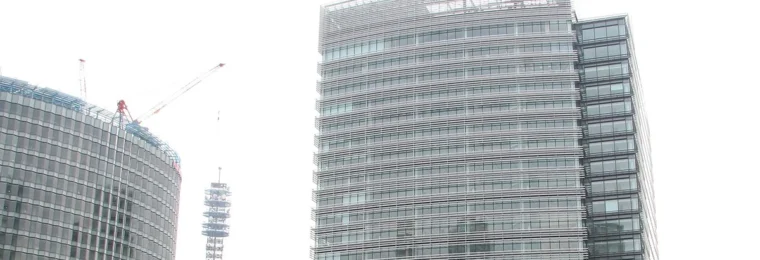 Nissan Global Headquarters building in Yokohama, Japan, with the Nissan sign visible near the top.