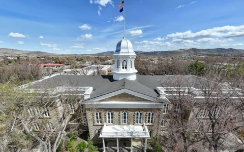 Nevada State Capitol building in Carson City beneath a blue sky.