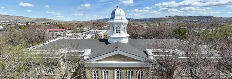 Nevada State Capitol building in Carson City beneath a blue sky.