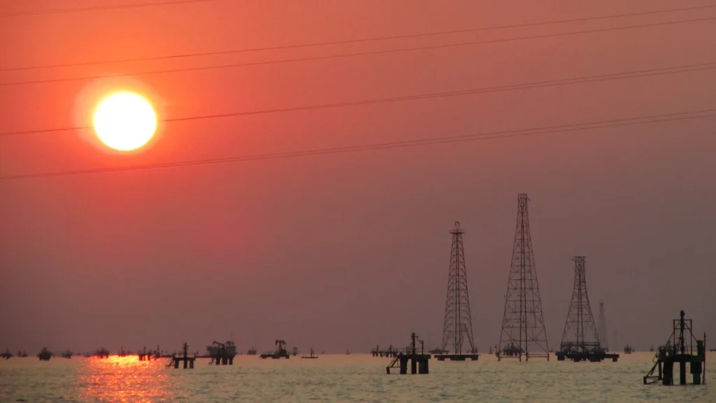 Oil drilling rigs on Lake Maracaibo near Lagunillas, Venezuela, at sunset.