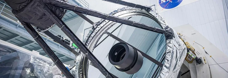 Optical engineer Bente Eegholm inspects the 2.4-meter primary mirror for NASA’s Nancy Grace Roman Space Telescope.