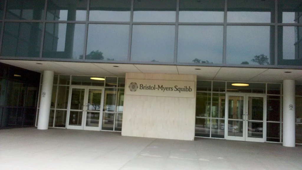 Entrance to a Bristol-Myers Squibb building in New Jersey with company signage.