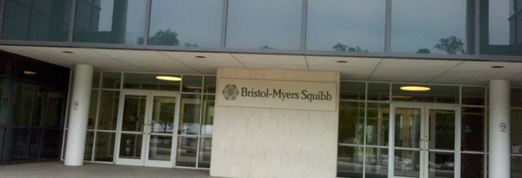 Entrance to a Bristol-Myers Squibb building in New Jersey with company signage.