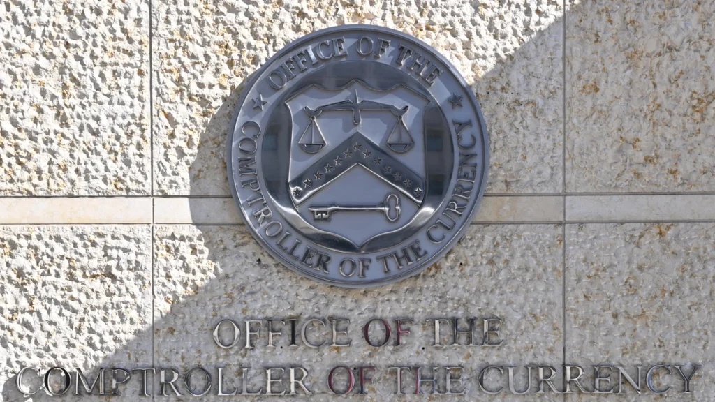 Office of the Comptroller of the Currency seal and name displayed outside its Washington headquarters.