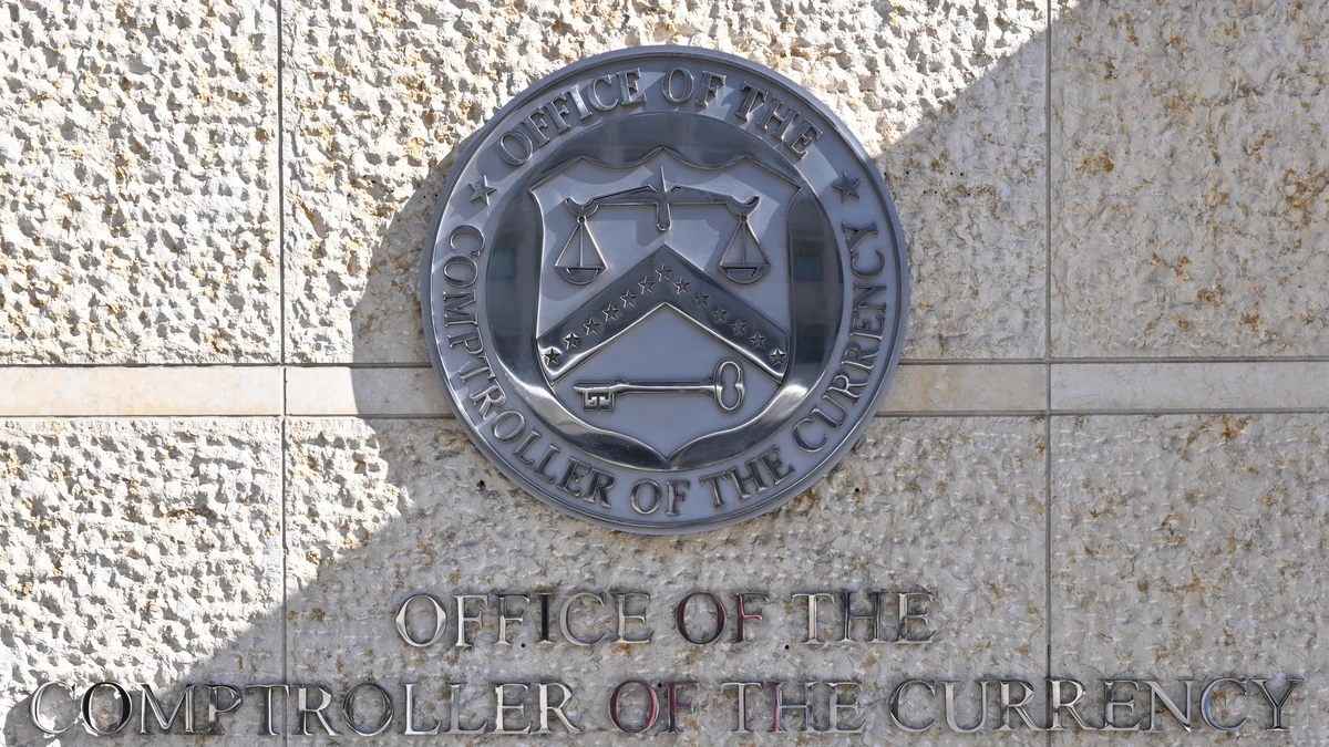 Office of the Comptroller of the Currency seal and name displayed outside its Washington headquarters.