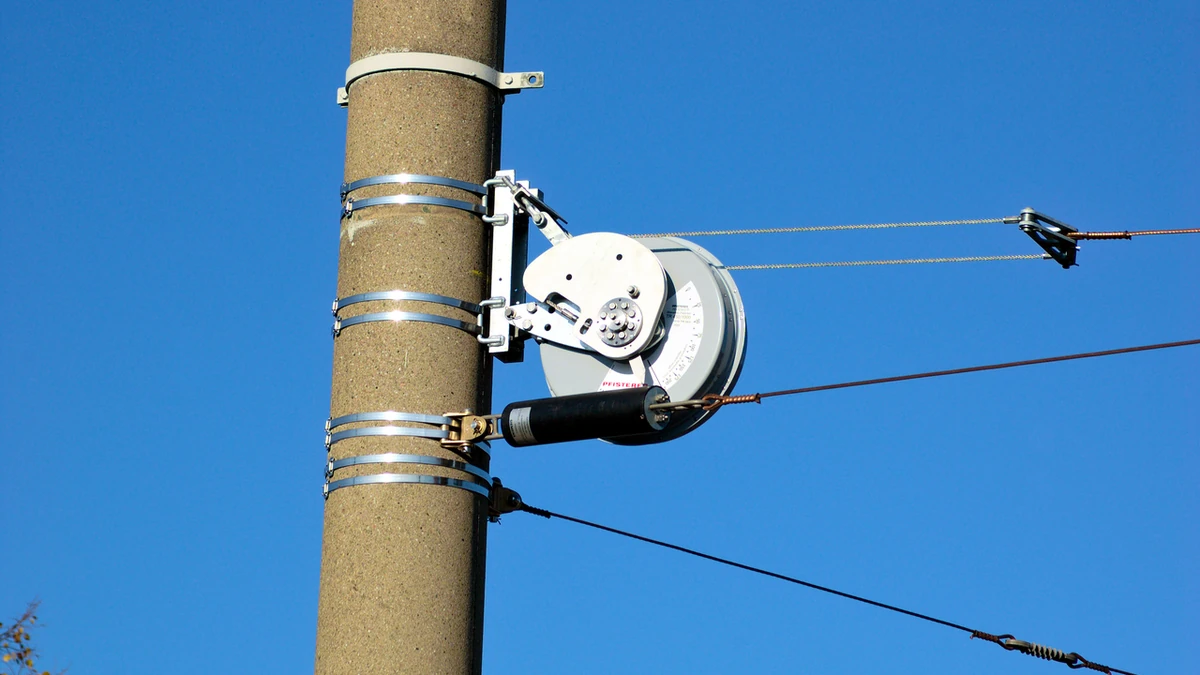 PFISTERER-branded overhead wire tensioner mounted on a utility pole.