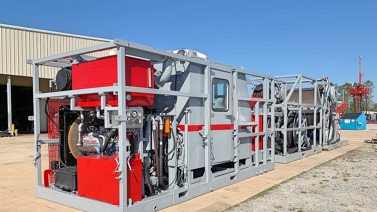 Skid-mounted coiled tubing unit at an industrial site.