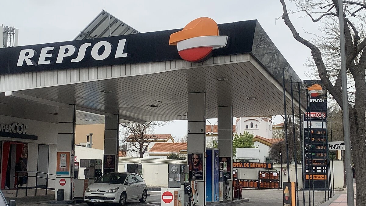 Repsol petrol station in Spain with fuel prices displayed on a roadside board.