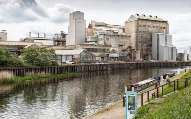 Industrial buildings at the Tata Chemicals Winnington plant beside a waterway in Northwich, England.