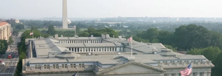U.S. Treasury Building in Washington, D.C., with the Washington Monument in the background.