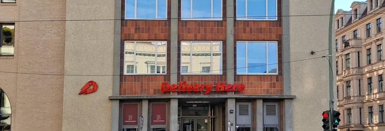 Delivery Hero office building with company signage in Berlin.