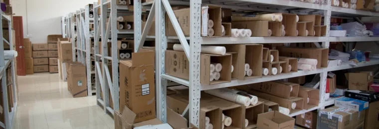Boxes and goods stored on metal shelving in a warehouse.
