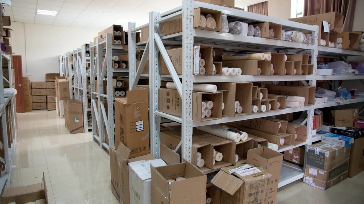 Boxes and goods stored on metal shelving in a warehouse.