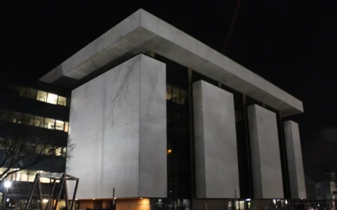Institute for Social Research building at the University of Michigan in Ann Arbor at night.