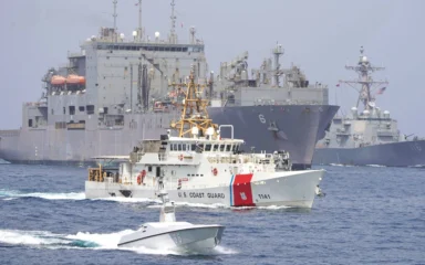 U.S. Coast Guard and U.S. Navy vessels transiting the Strait of Hormuz.