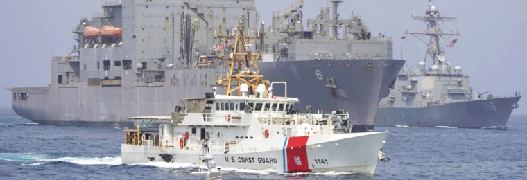 U.S. Coast Guard and U.S. Navy vessels transiting the Strait of Hormuz.
