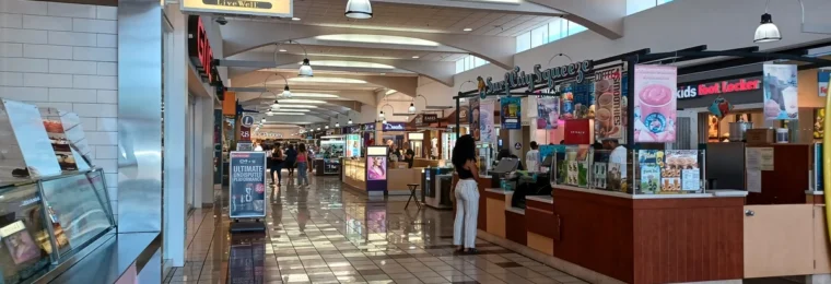 Interior of Weberstown Mall in Stockton, California, with retail storefronts and shoppers.